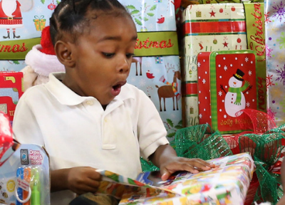 Little Boy Opening Holiday Gifts Happy