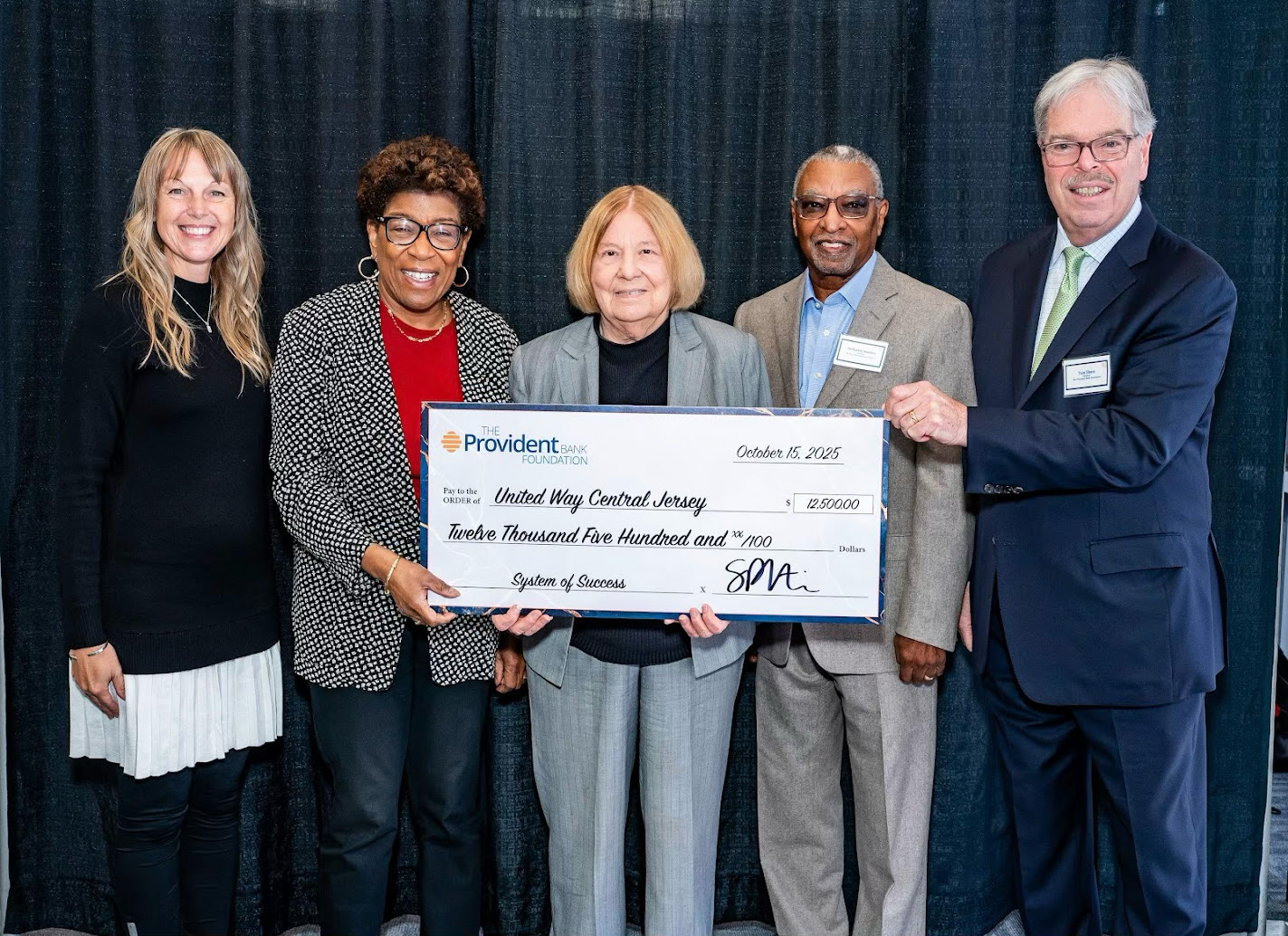 Gloria Aftanski and Dale Callender accepting a $12,500 check from the Provident Bank Foundation.