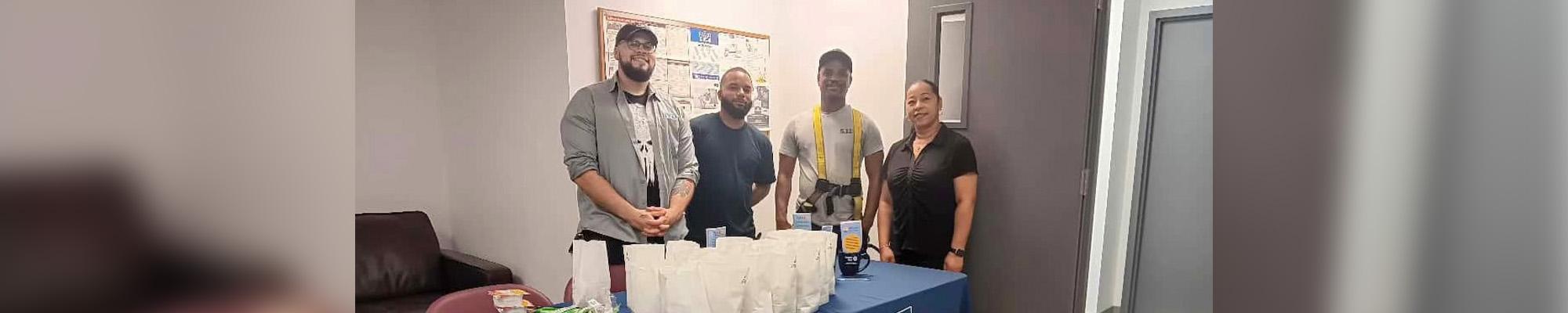 Employees of TBC Corporation, an automotive services company in Avenel, assembled bags of healthy snack items provided by United Way Worldwide.